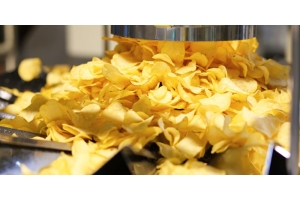 Potato chips move through a package filling line